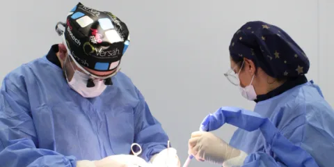 Equipo quirúrgico de CPH Salud operando en pabellón con lupas y mascarilla